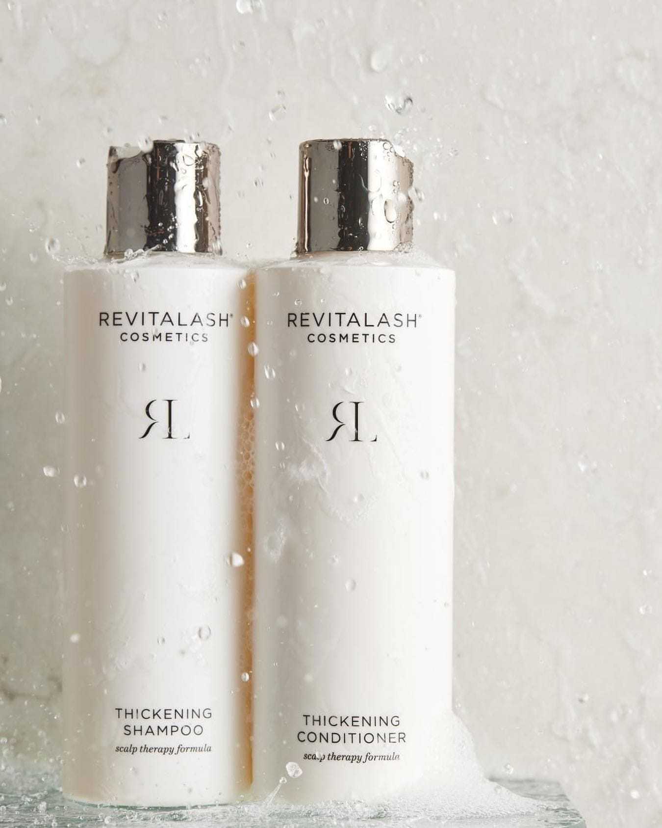 RevitaLash shampoo and conditioner bottles with water droplets.
